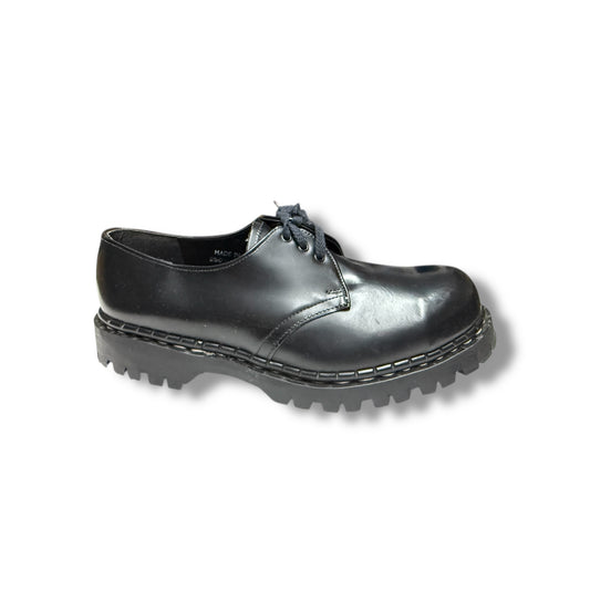 A black leather steel cap shoe with a lace-up closure and a thick sole.