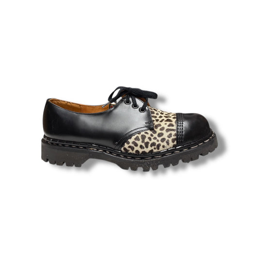 A black leather shoe with leopard print detailing on the top and a cap toe style.