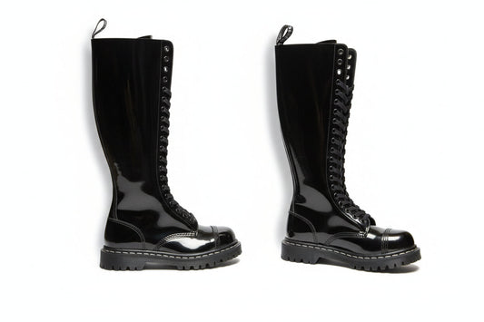 A black patent leather boot with a high sole and lace-up front featuring 20 eyelets.