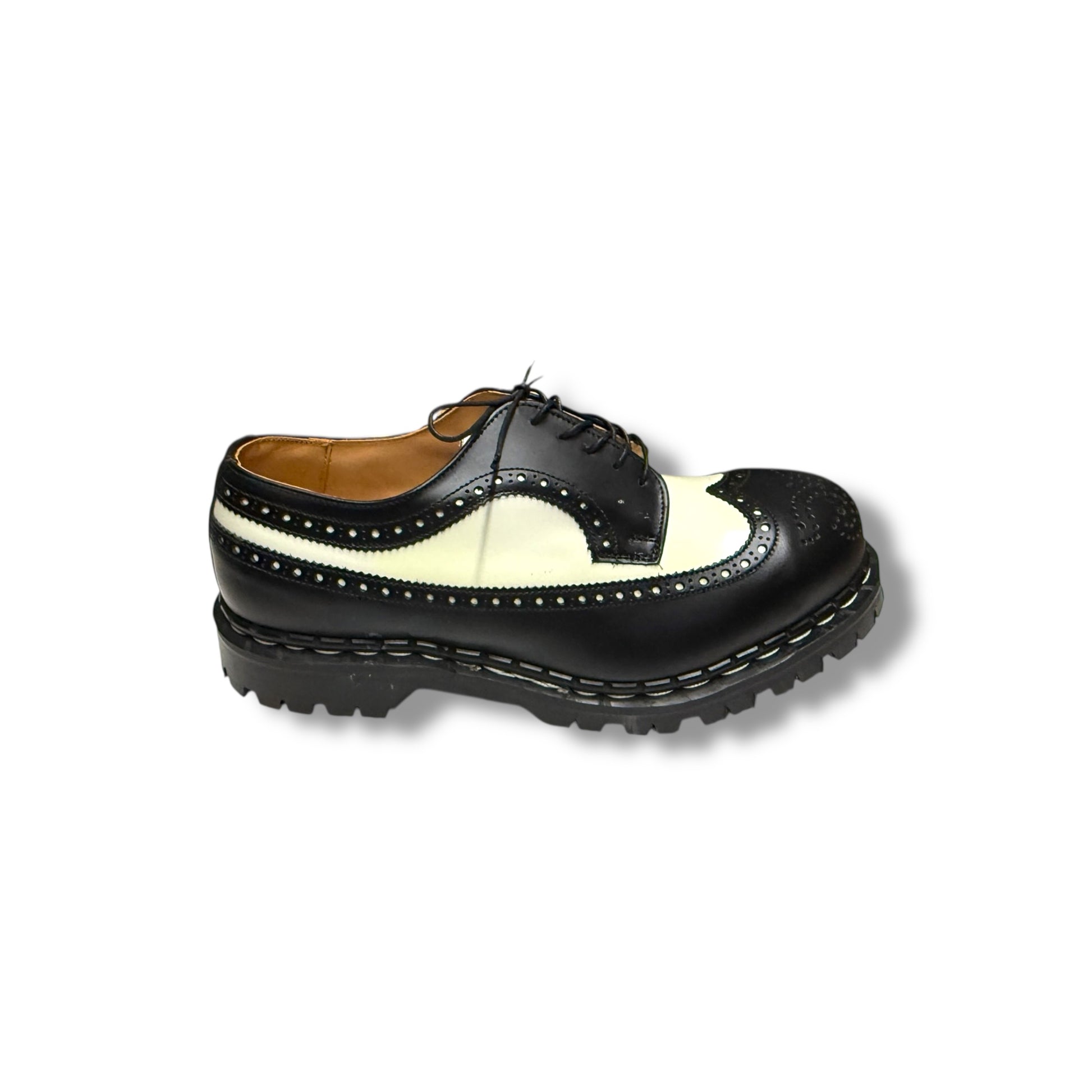 A black and white Gripfast 5 eye shoe with a lace-up closure and a grippy sole.