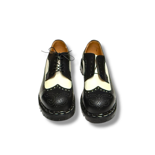 Black and white brogue shoes on a white background