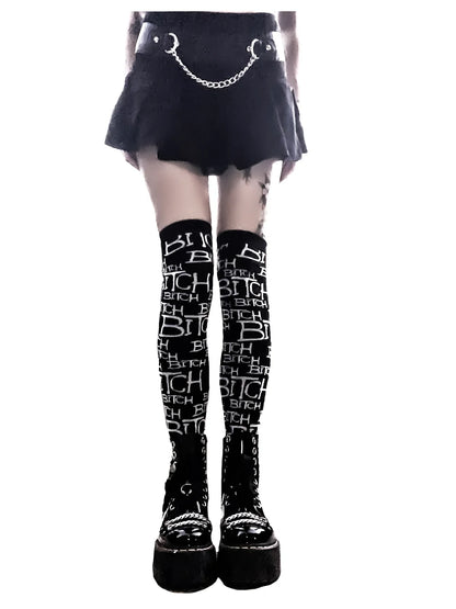 Lip service black knee-high socks with white text worn by a person on a white background