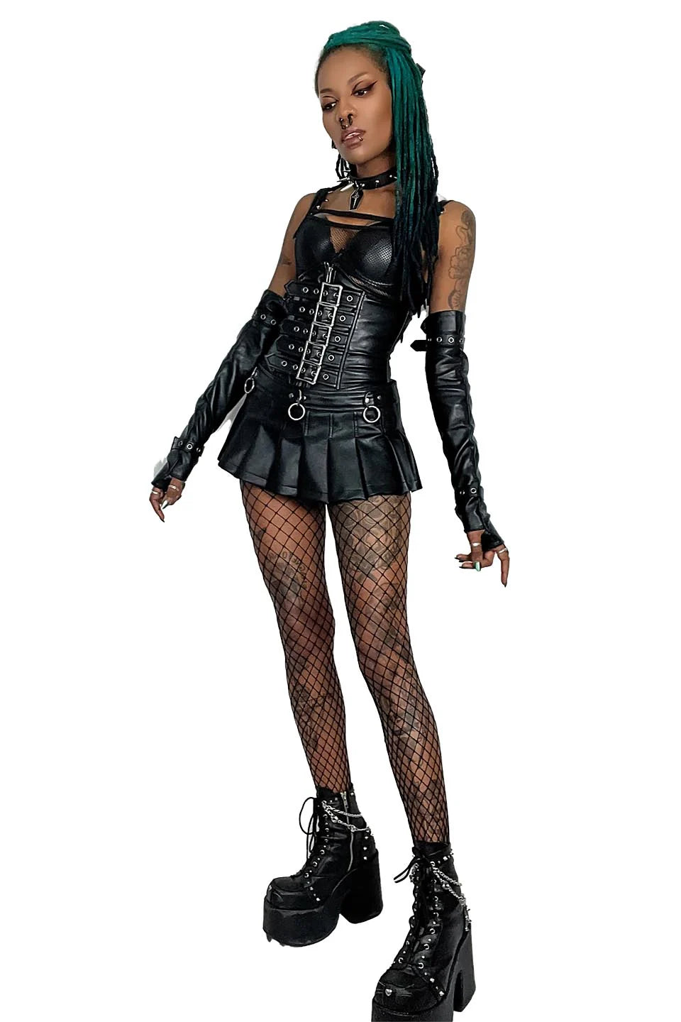 Person wearing a lip service black leather outfit with fishnet stockings and high boots on a white background