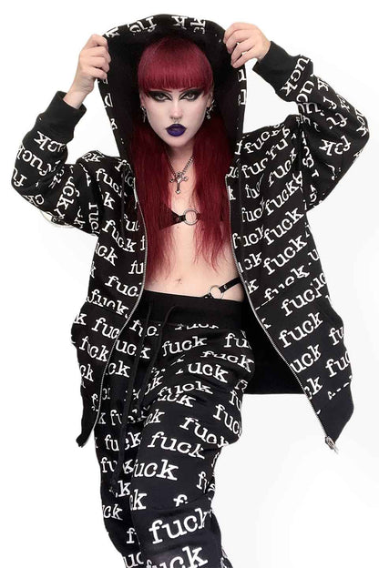 Person wearing a black hoodie with white text and matching pants on a white background
