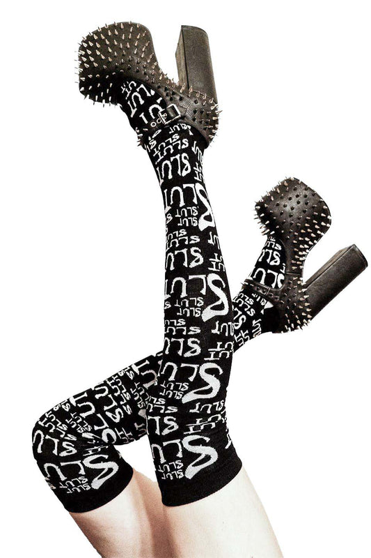 Black knee-high socks with white text and black spiky gloves on a white background