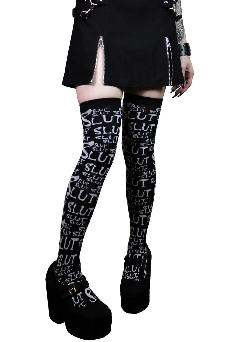 Black lip service knee-high socks with white text worn by a person on a white background
