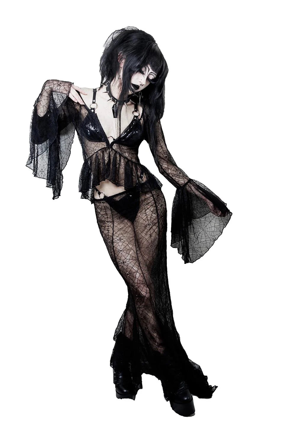 Person wearing a lip service black lace lingerie set on a white background