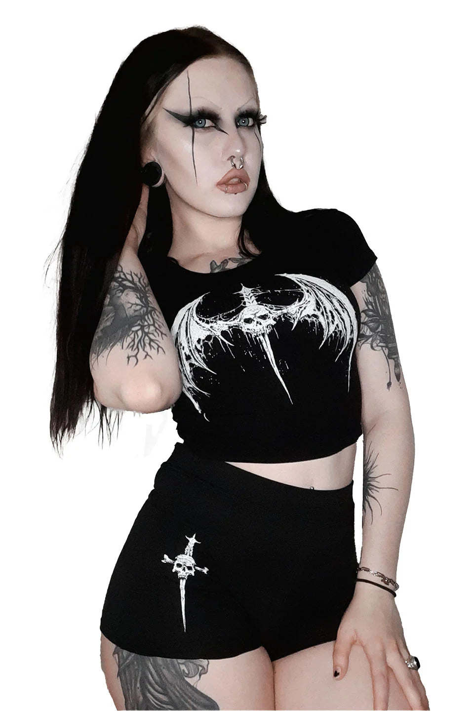 Person wearing a lip service black crop top and shorts with white designs on a white background