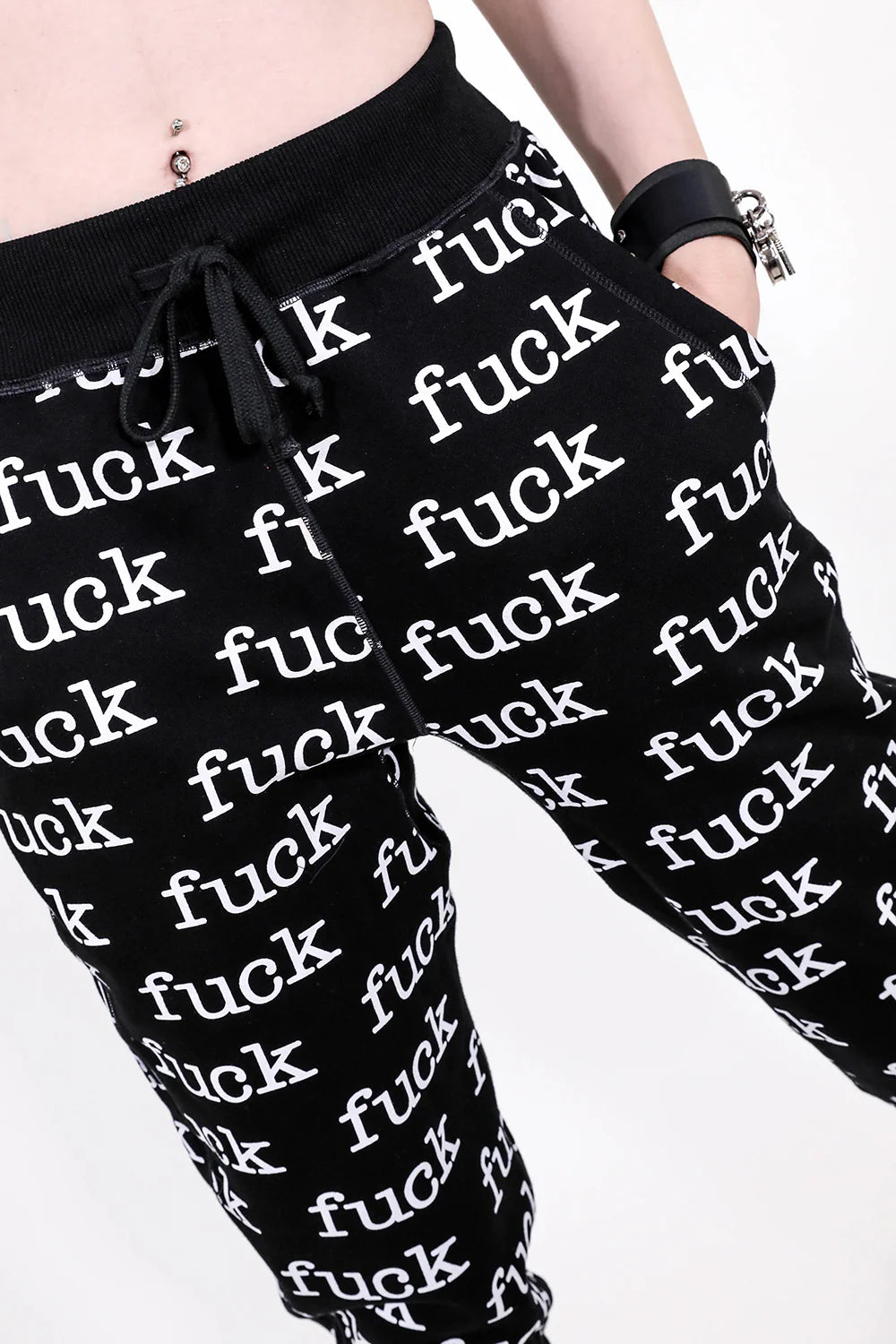 Black pants with 'fuck' printed repeatedly on a white background