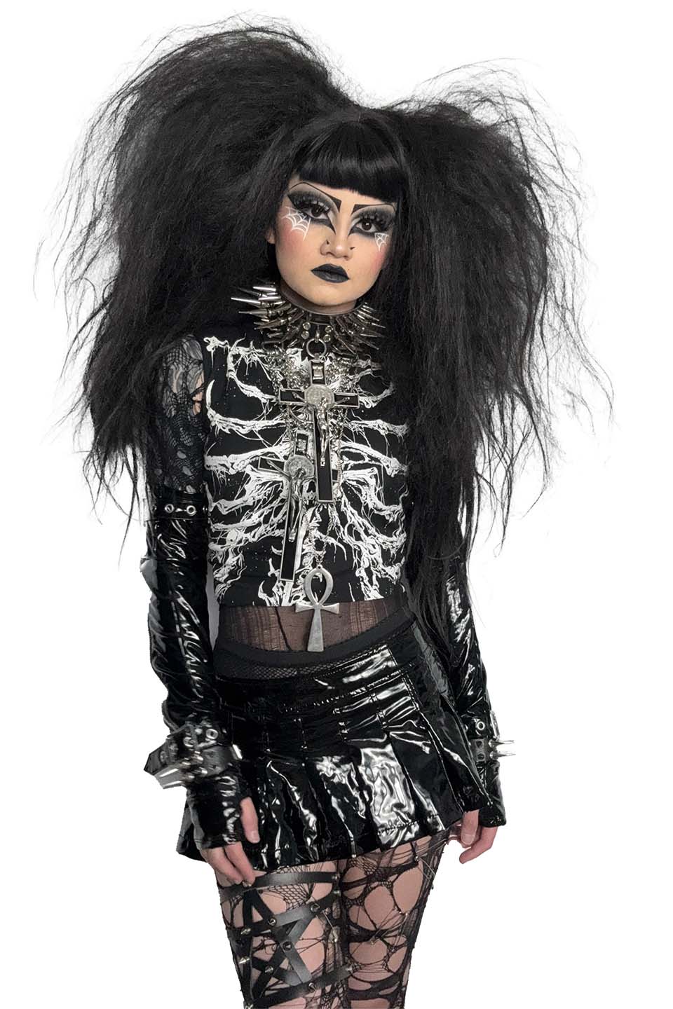 Person wearing a lip service black and silver skeleton-themed outfit with long hair on a white background