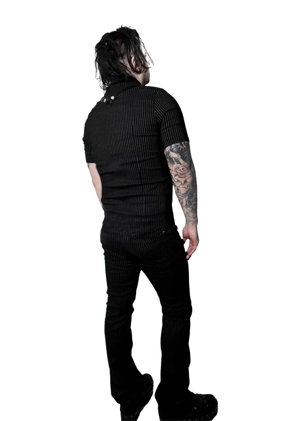 Person wearing a lip service black ribbed sweater and pants on a white background