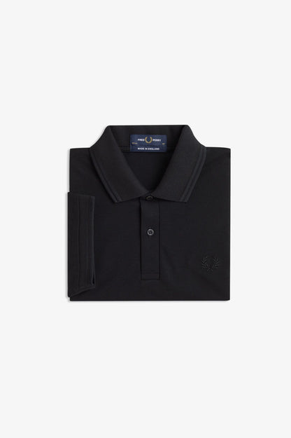 Folded black polo shirt with a brand logo on a white background