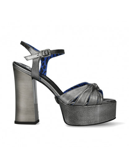 Silver platform sandal with a high heel on a white background