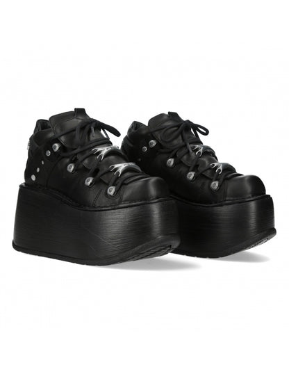 Black platform sneakers on a white background