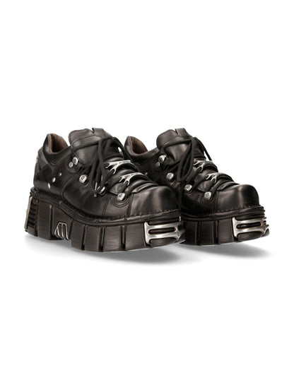 Pair of black platform sneakers with metallic accents on a white background