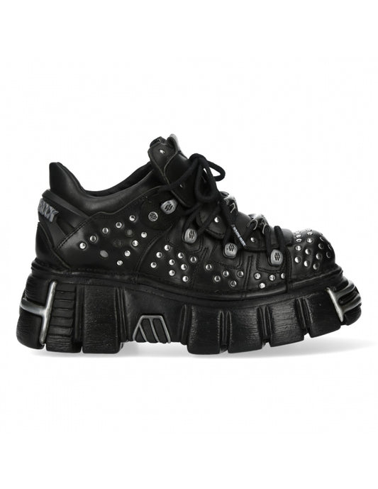 Black studded sneaker on a white background