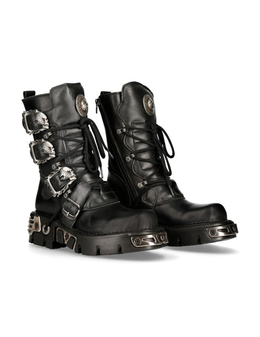 Pair of black leather boots with metal accents on a white background
