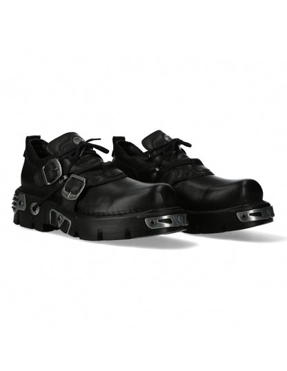 Pair of black leather shoes with buckles on a white background