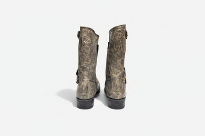Pair of worn leather boots on a white background