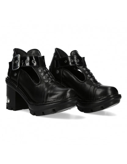 Pair of black leather boots with buckles on a white background