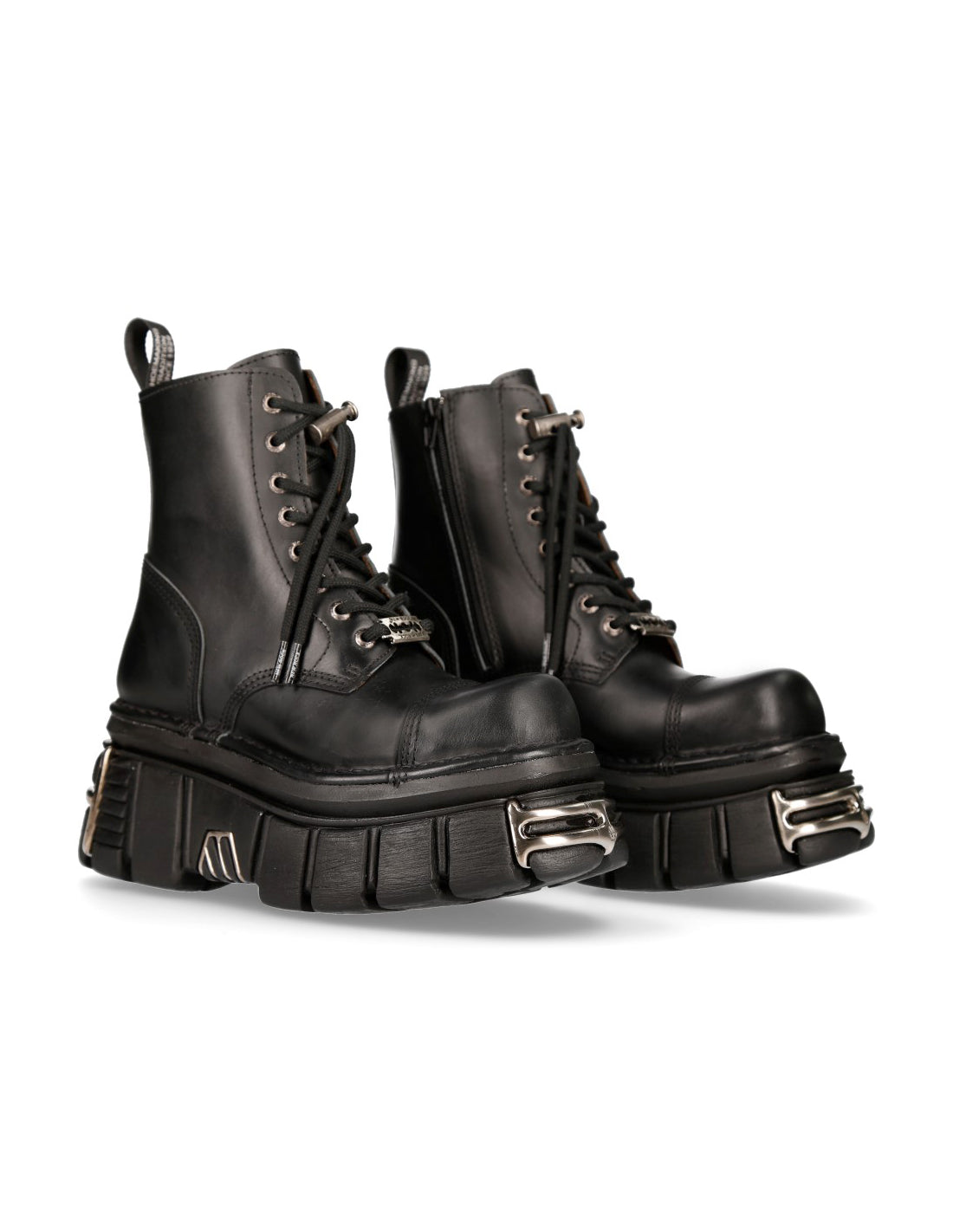 Pair of black leather boots with metal accents on a white background