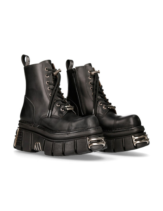 Pair of black leather boots with metal accents on a white background