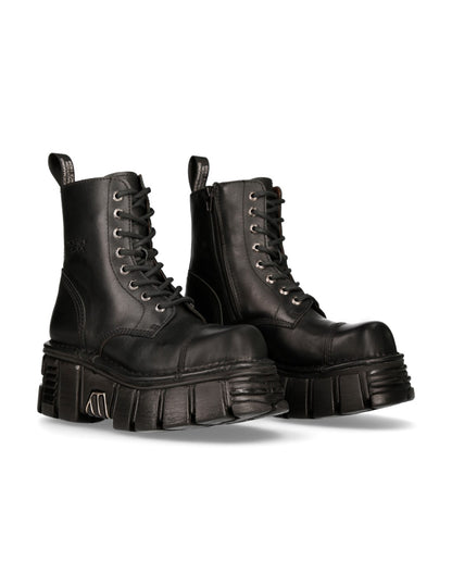 Pair of black leather boots with thick soles on a white background