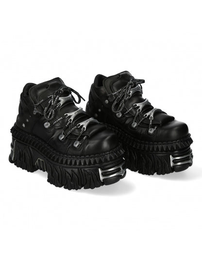 Pair of black platform boots on a white background