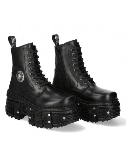 Pair of black leather boots with unique sole design on a white background