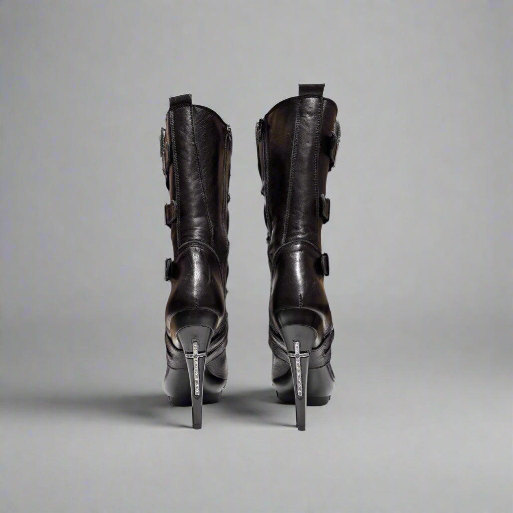 Pair of black high-heeled boots on a white background
