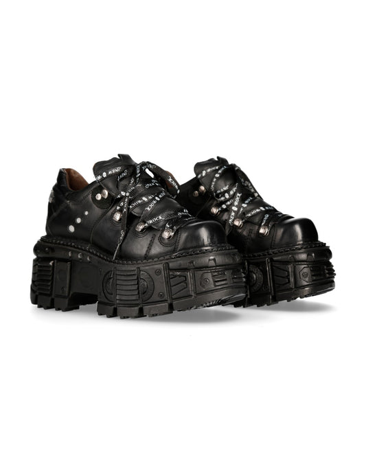 Pair of black platform shoes with chunky soles on a white background