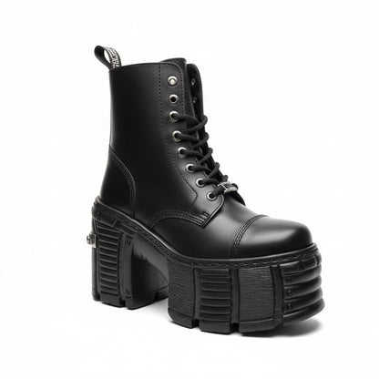 Black platform boot with chunky sole on a white background