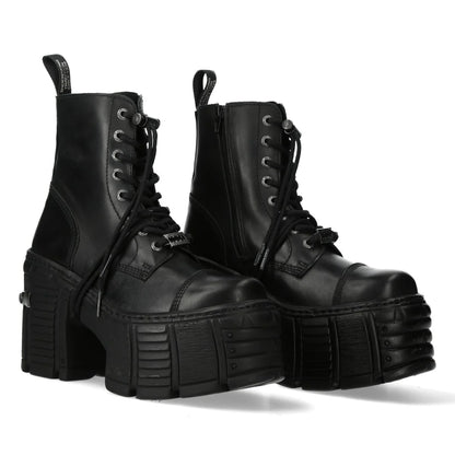 Pair of black platform boots on a white background