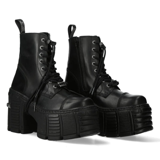 Pair of black platform boots on a white background