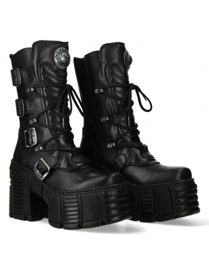 Black leather platform boots with buckles on a white background