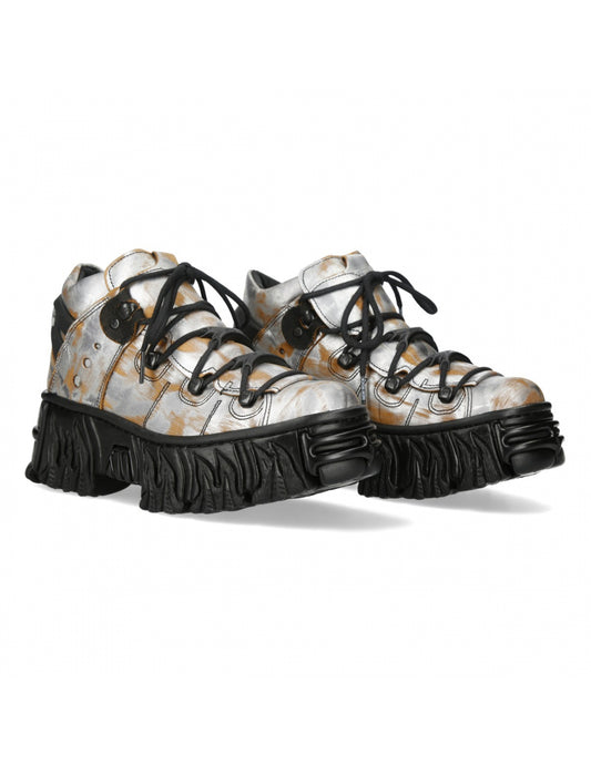 Pair of white platform shoes with black soles on a white background
