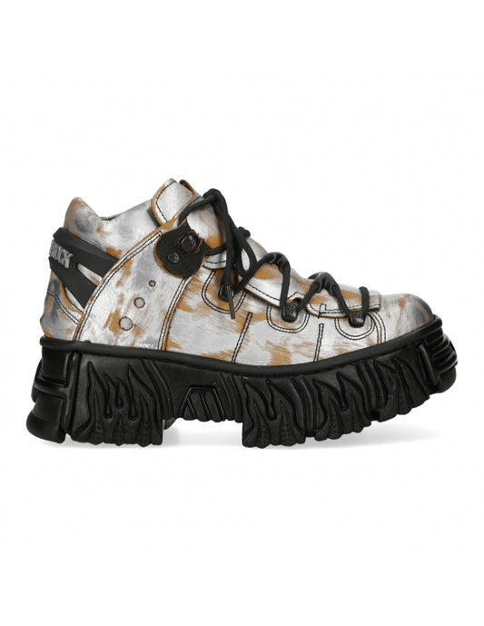 White sneaker with black sole on a white background