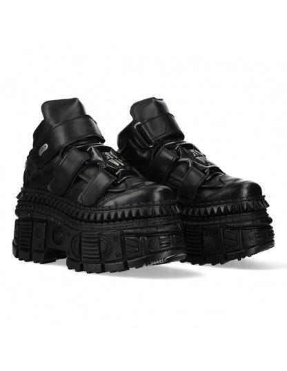 Black high-top sneakers with thick soles on a white background