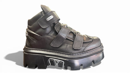 Black high-top sneaker with thick sole on a white background