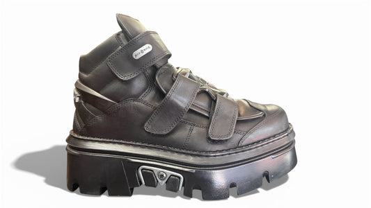 Black high-top sneaker with thick sole on a white background