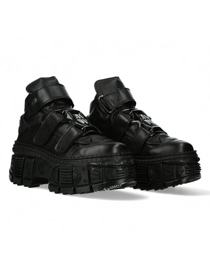 Pair of black high-top sneakers with thick soles on a white background