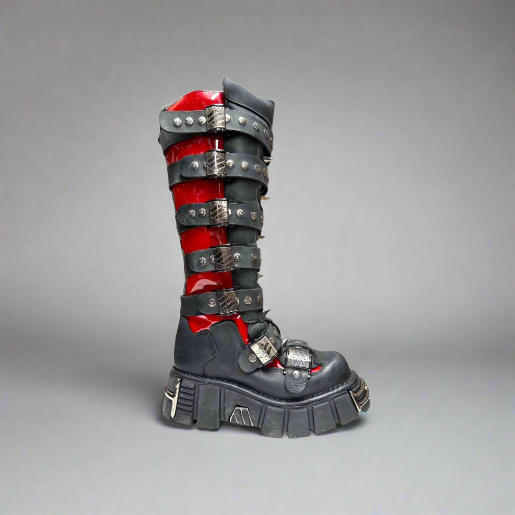 Black and red boot with metallic accents on a white background