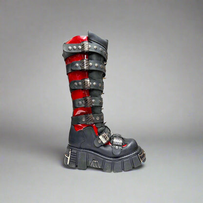 Black and red boot with metallic accents on a white background