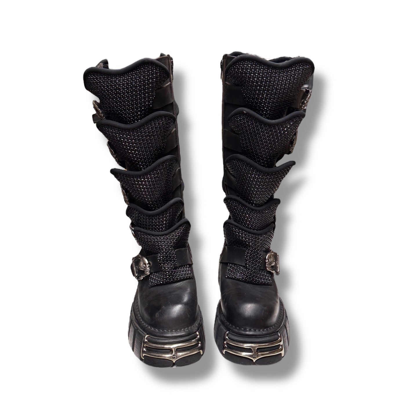 Pair of black knee-high boots with multiple straps on a white background