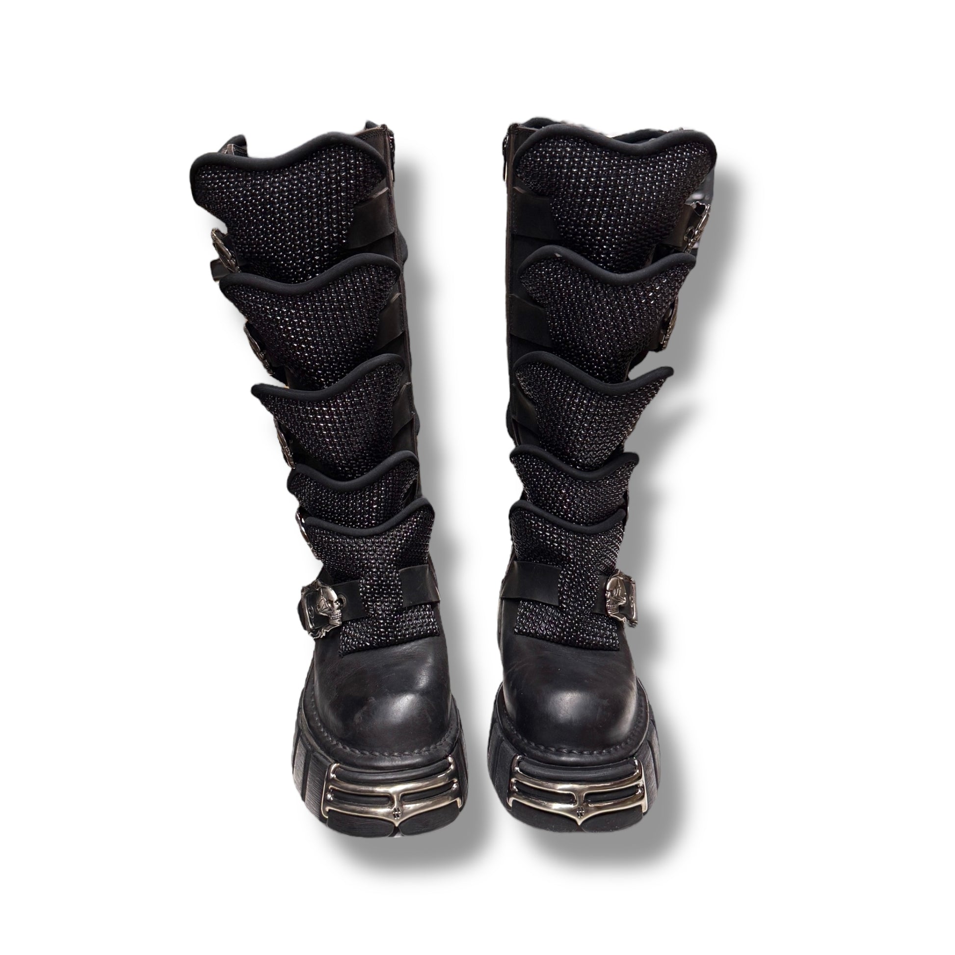 Pair of black knee-high boots with multiple straps on a white background