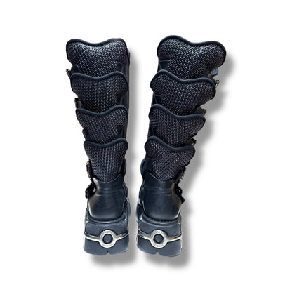 Pair of black knee-high boots with textured design on a white background