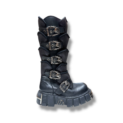 Black boot with metal buckles on a white background