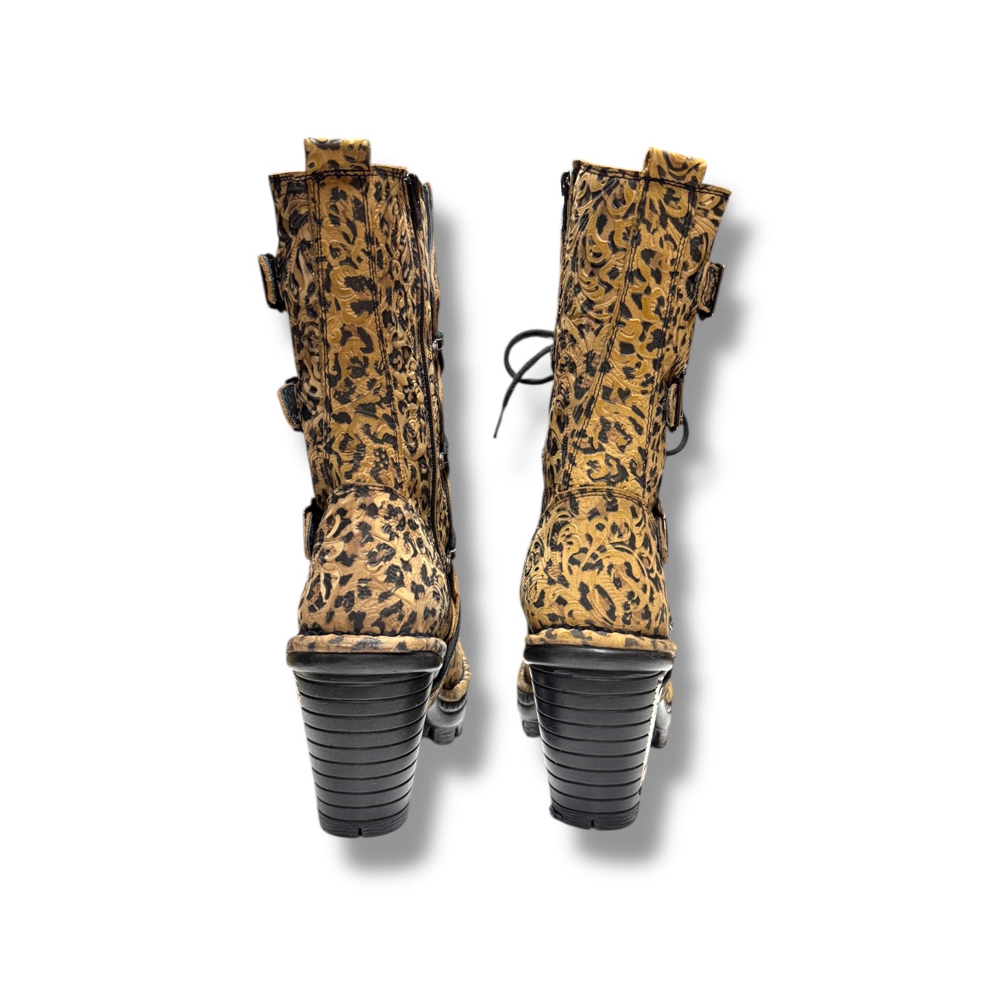 Pair of leopard print boots with black soles on a white background