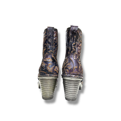 Pair of cowboy boots with detailed design on a white background