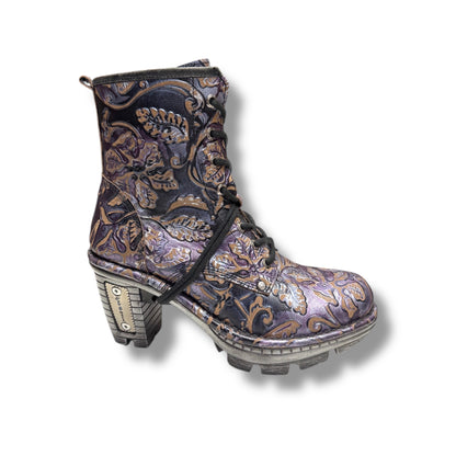 Decorative boot with intricate patterns on a white background